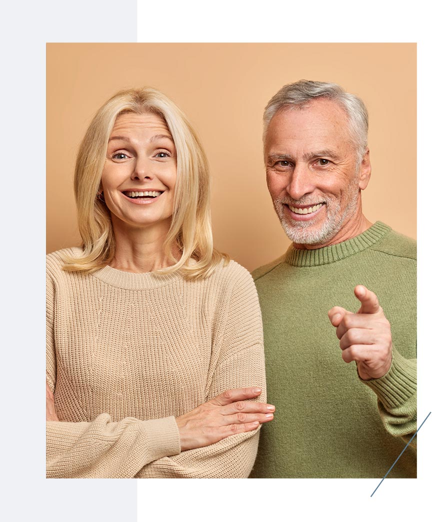 A Happy Couple Smiling After Dental Implant Treatment