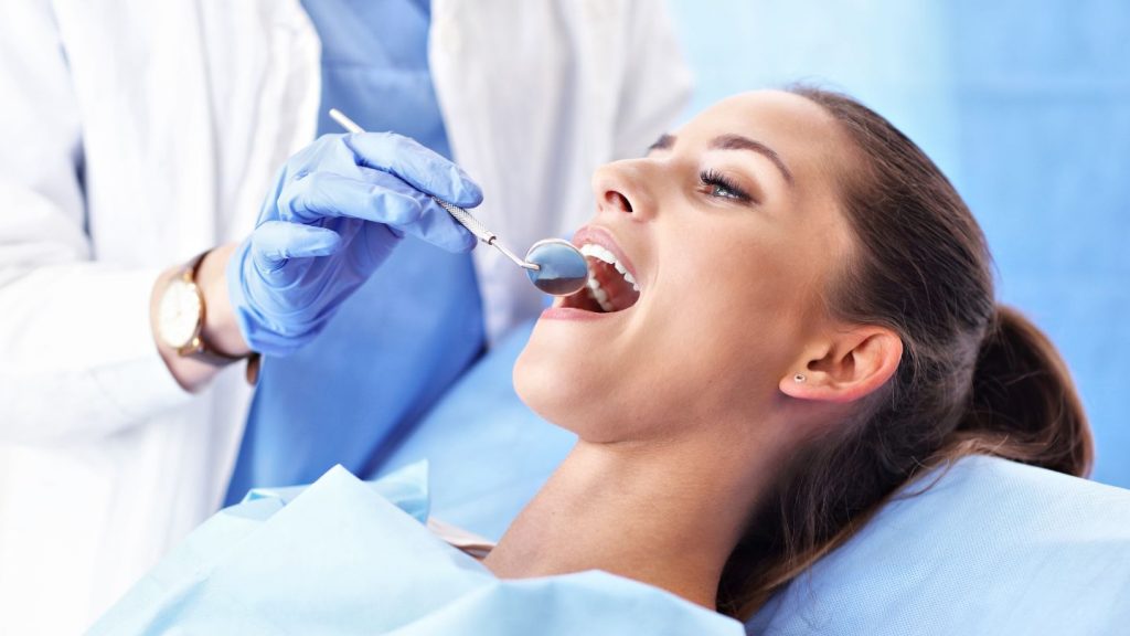 Patient Getting Her Teeth Checked By The Dentist